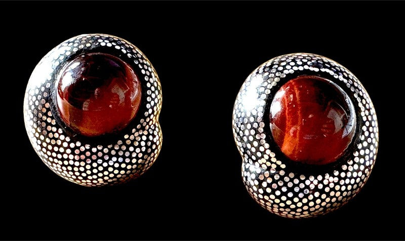 Nailhead form in ebony and sterling with red tiger's eye cabochon