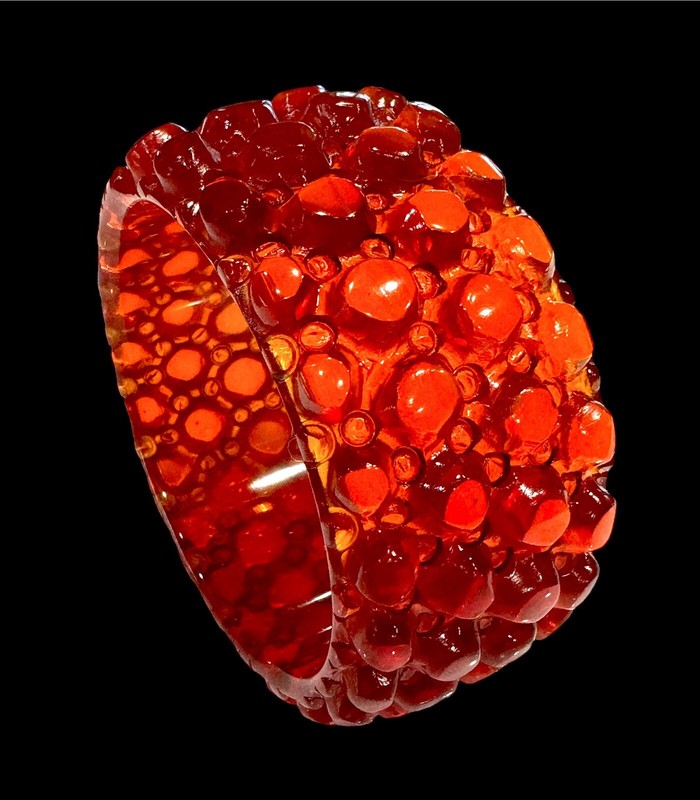 Heavy hand carving worked around the translucent band