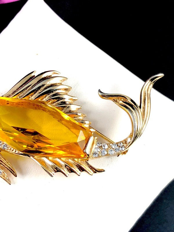 Ruby red rhinestone serving as the fish's eye